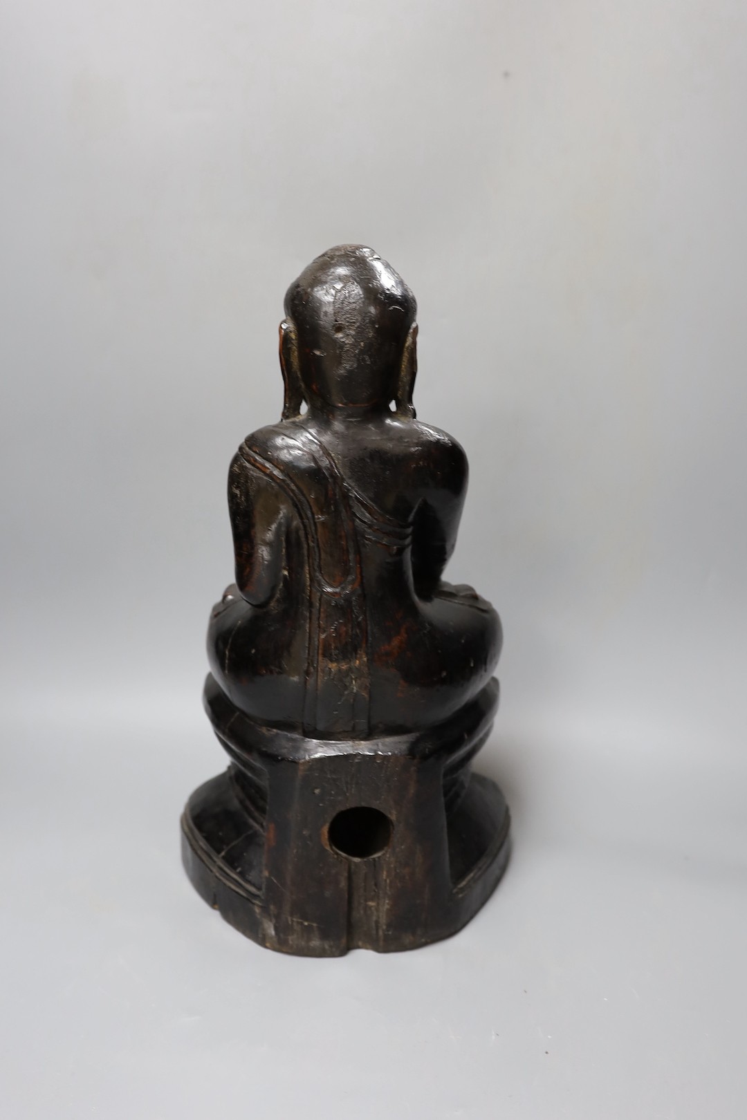 An 18th/19th century Burmese lacquered wood seated figure of Buddha Shakyamuni, 40cm